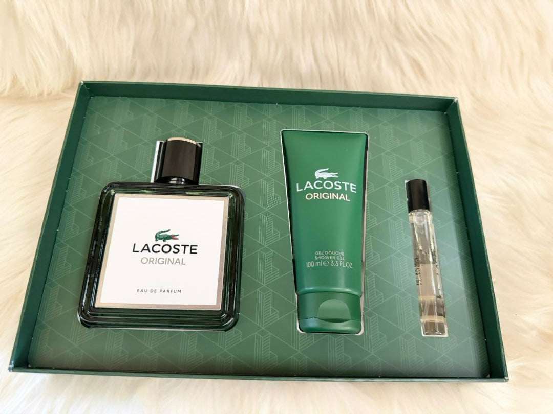 Perfume gift set tray with glass bottle, green tube, and small spray vial