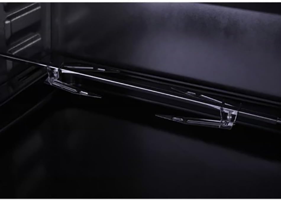 Chrome oven rack inside the dark oven cavity with metal side supports