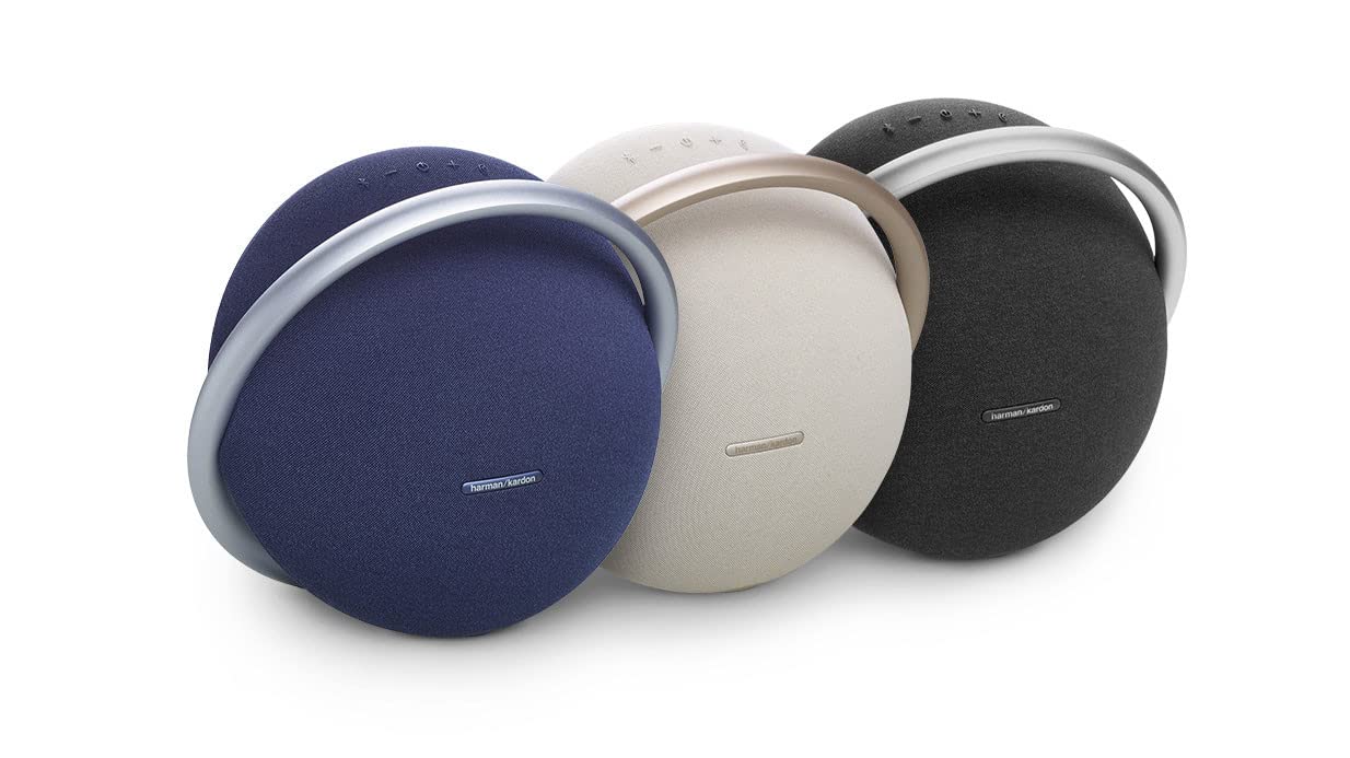Three portable Bluetooth speakers in blue, champagne, and black with metal rings.