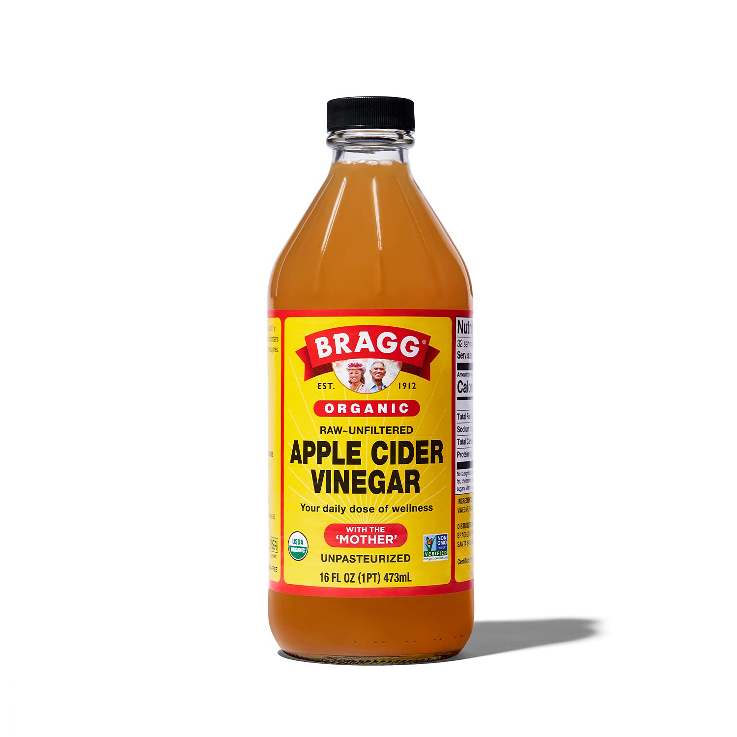 Bragg organic raw apple cider vinegar bottle with black cap; amber liquid and yellow label.