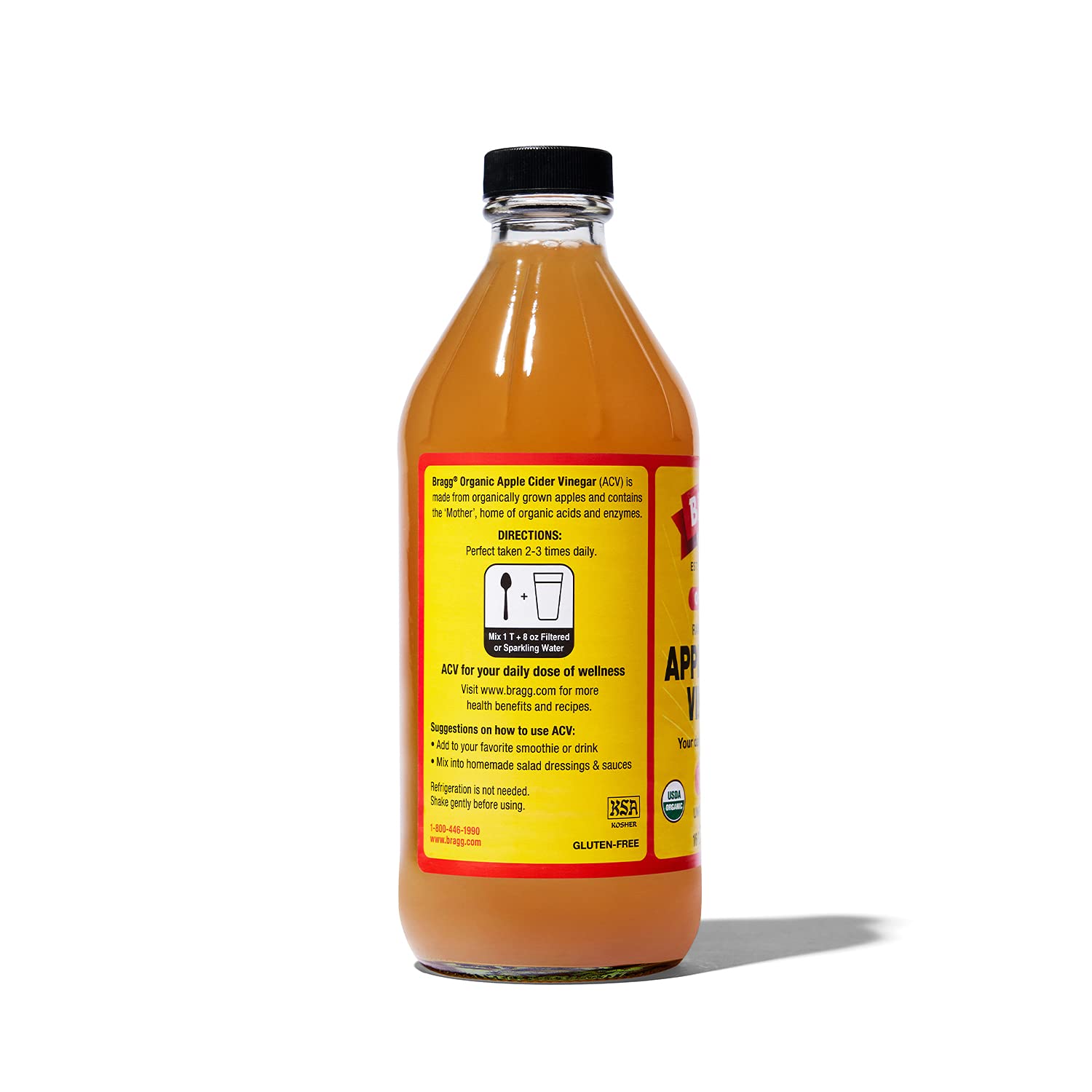 Bragg apple cider vinegar bottle with back label text and black cap; amber liquid.