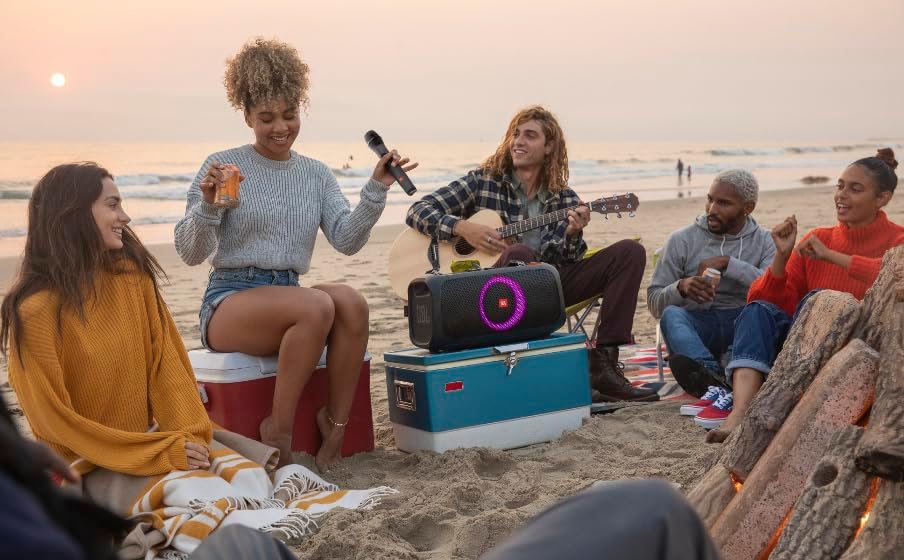 JBL microphone in a group music scene on the beach, with black mesh grille and body