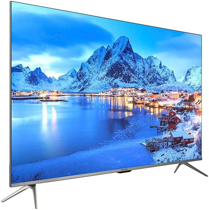 55-inch smart LED TV with slim bezel and stand, displaying snowy mountain landscape.