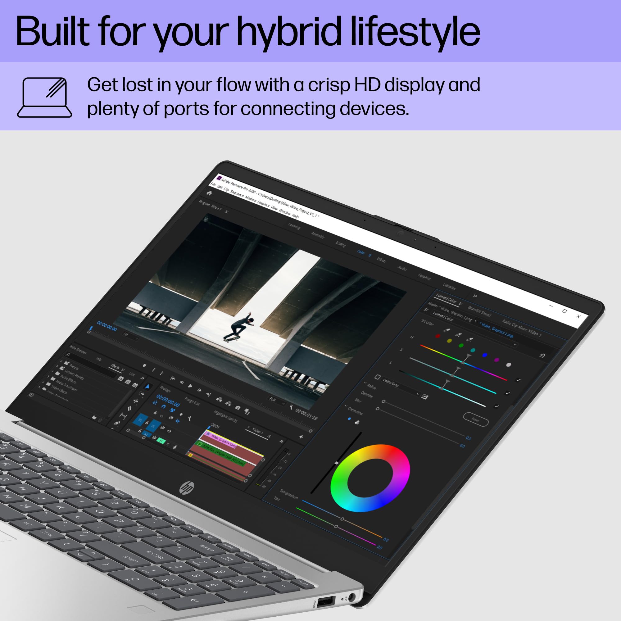 Silver HP laptop angled from above with backlit colorful keyboard glow