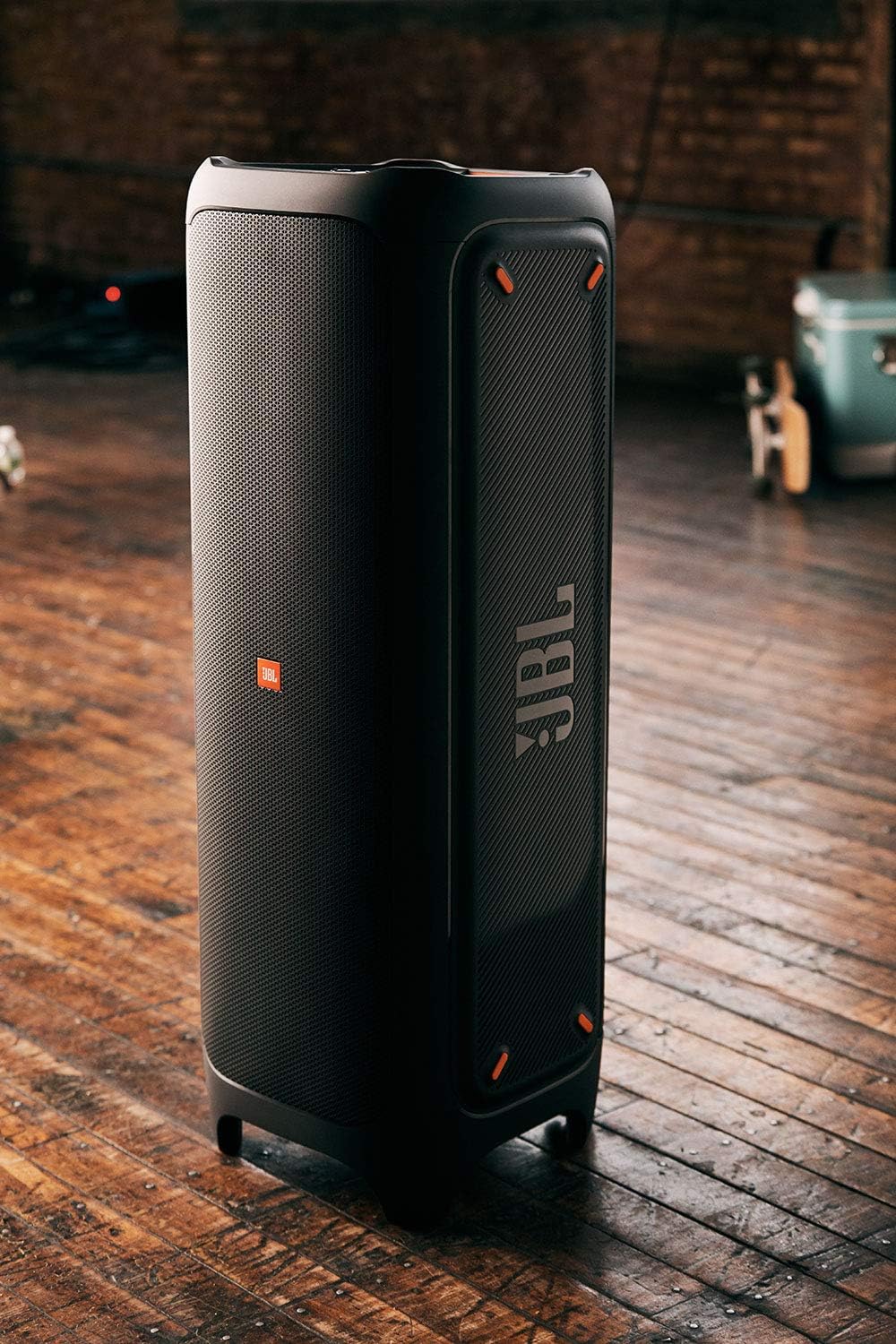 Black portable Bluetooth speaker standing with vertical JBL branding and LED accents