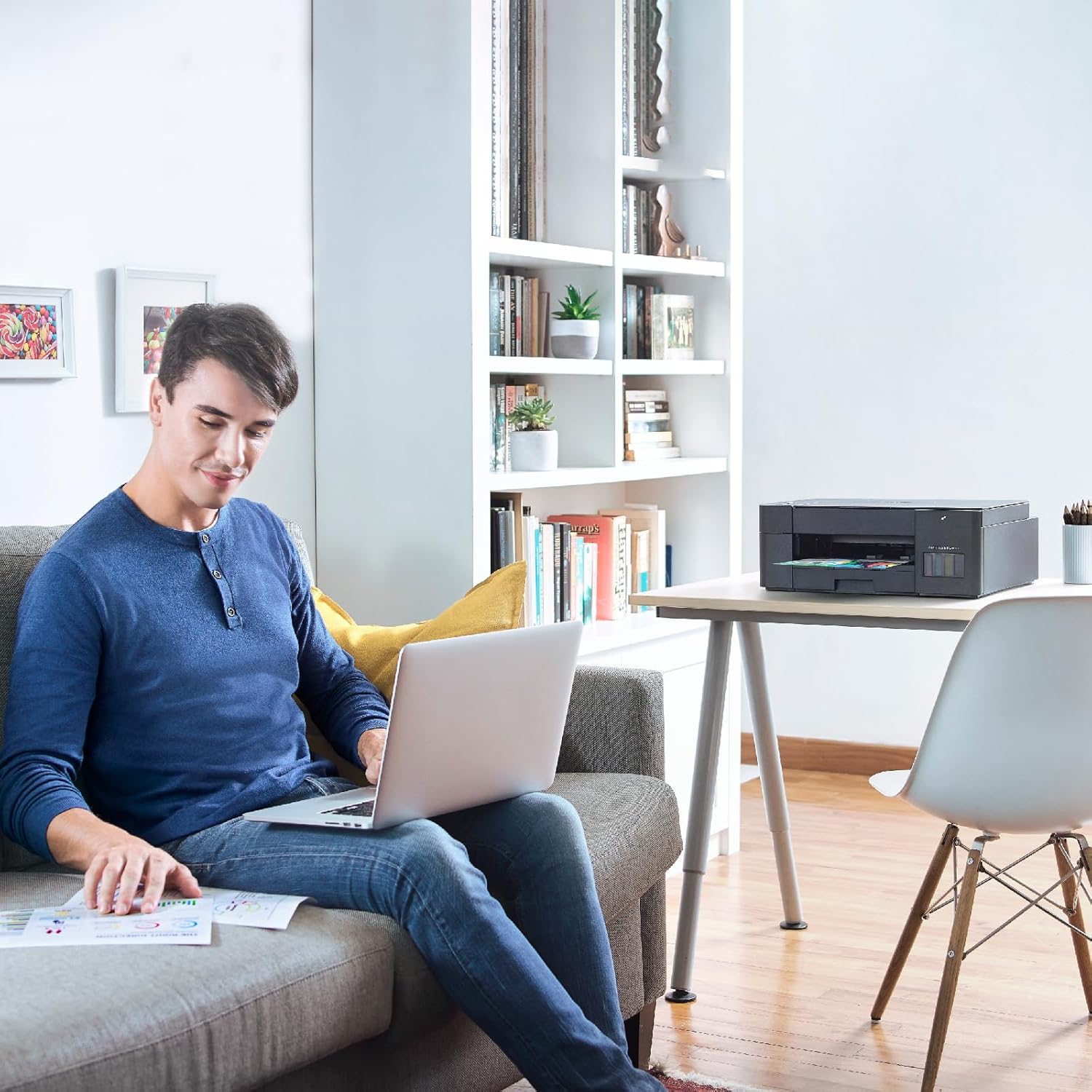 Wireless ink tank multifunction printer on desk in home office with laptop nearby