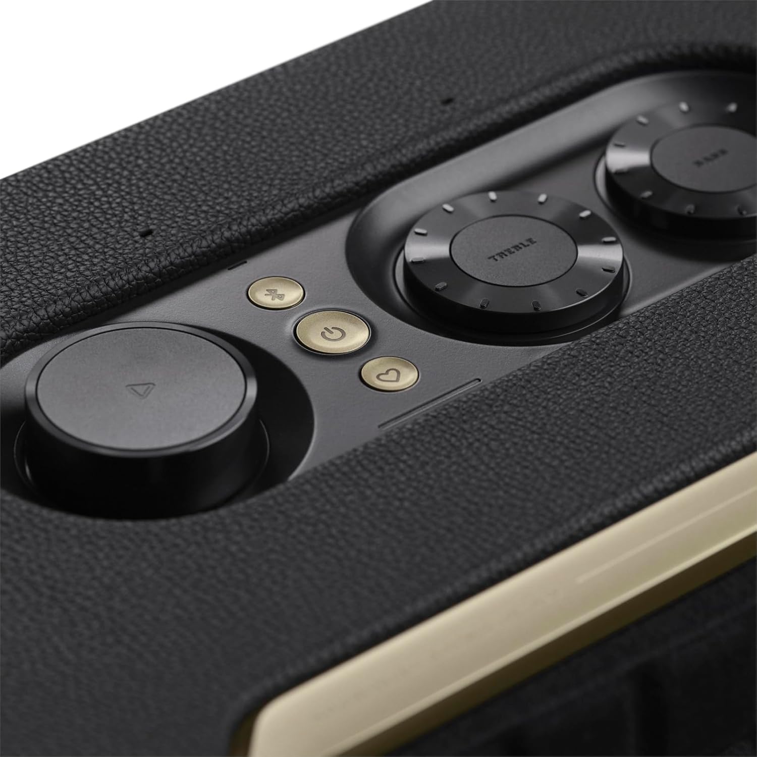 Close-up of black speaker top buttons and knobs with gold control accents