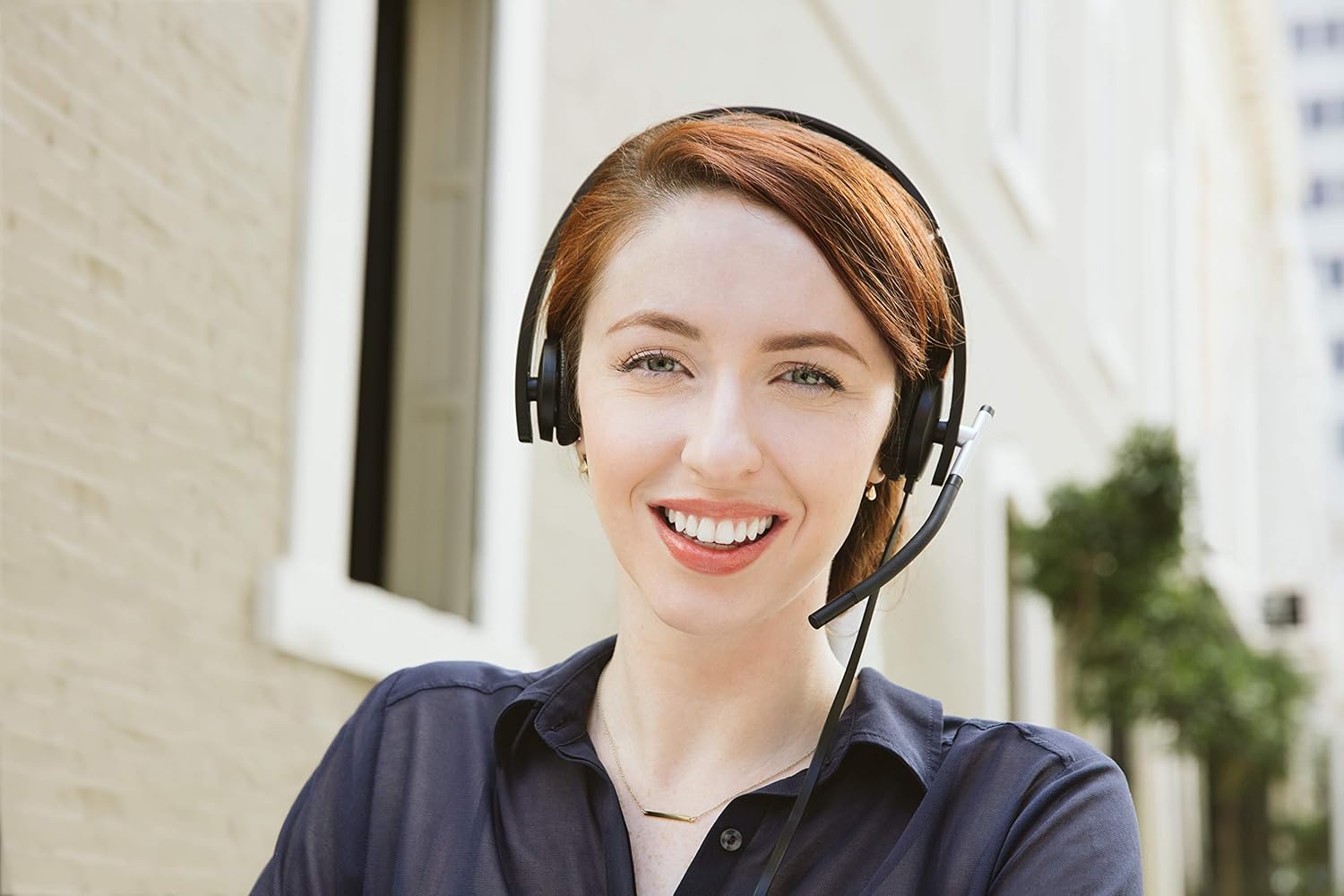 Woman wearing a black wired headset with boom microphone for calls