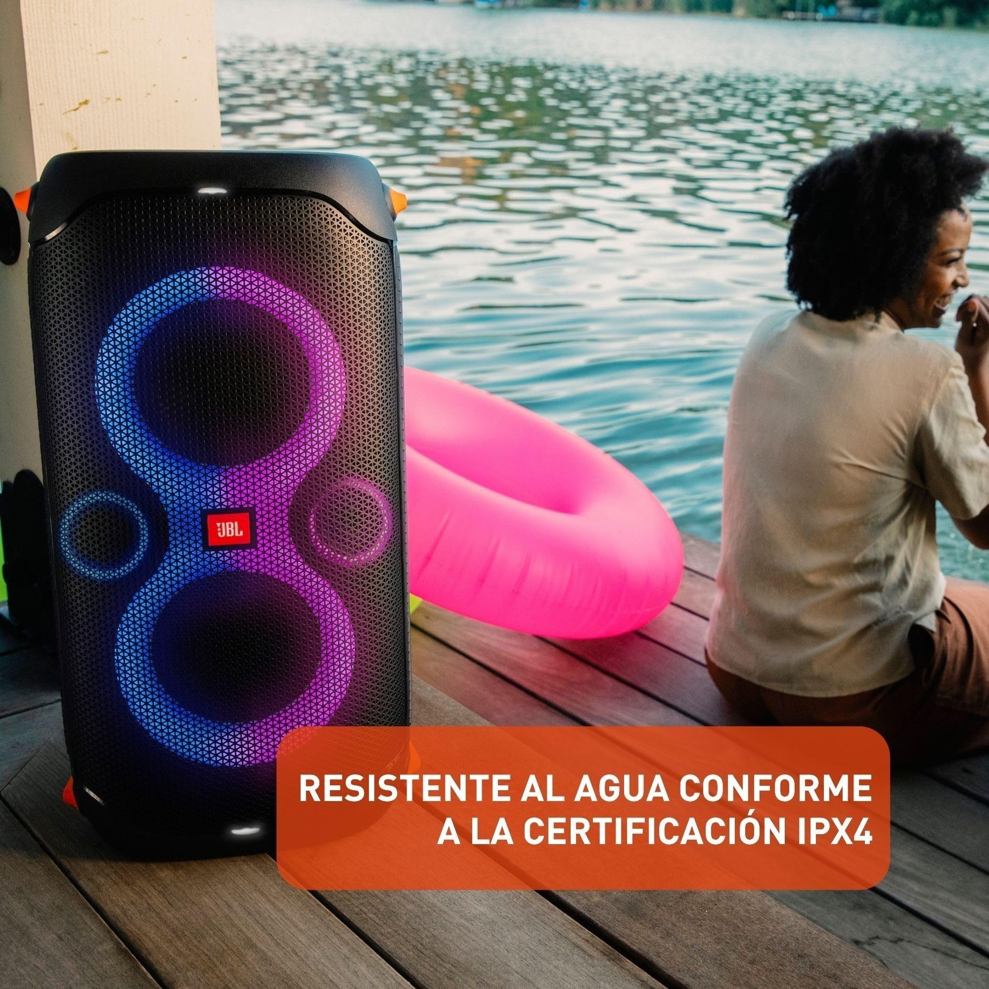 Black portable party speaker with purple-blue LED rings beside pool water and float ring.