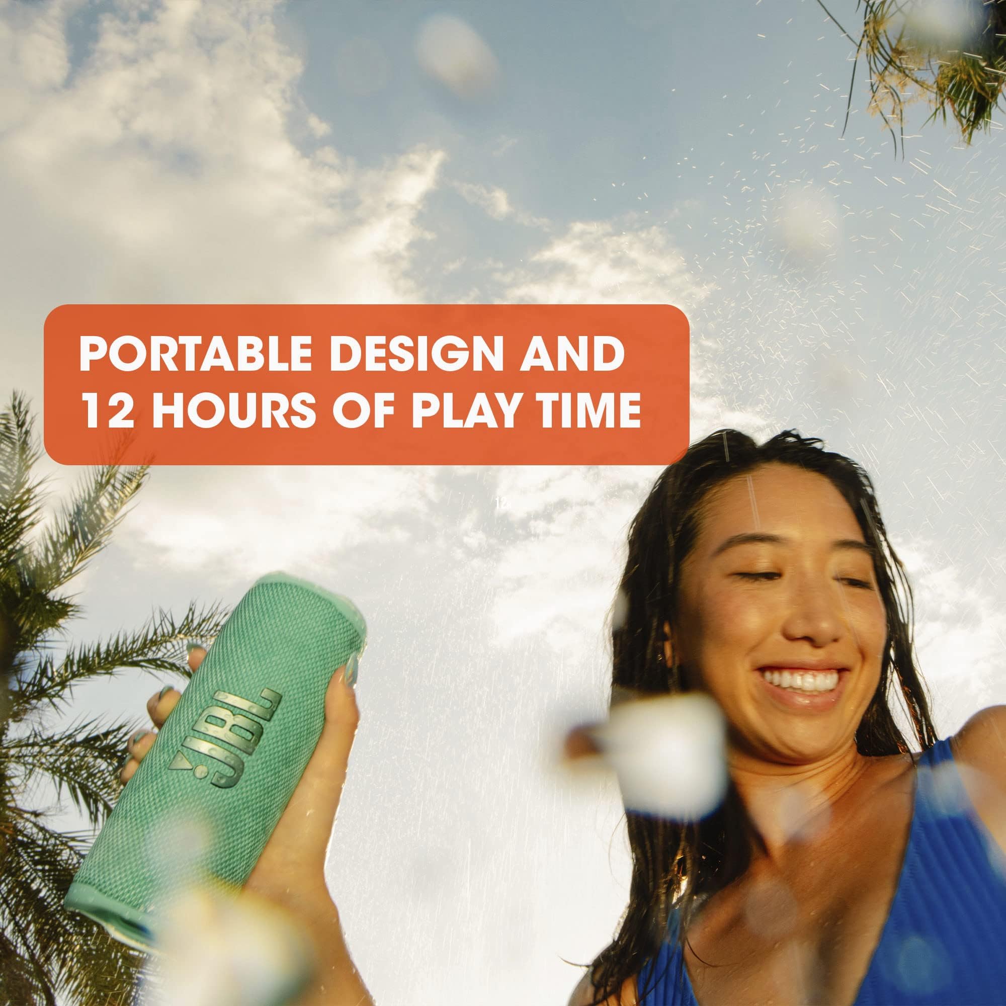 Green JBL Flip 6 portable speaker held in hand outdoors