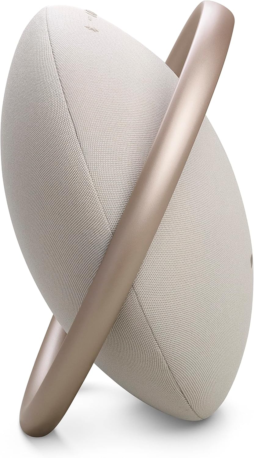 Champagne portable Bluetooth speaker with fabric grille and silver ring, angled side view.
