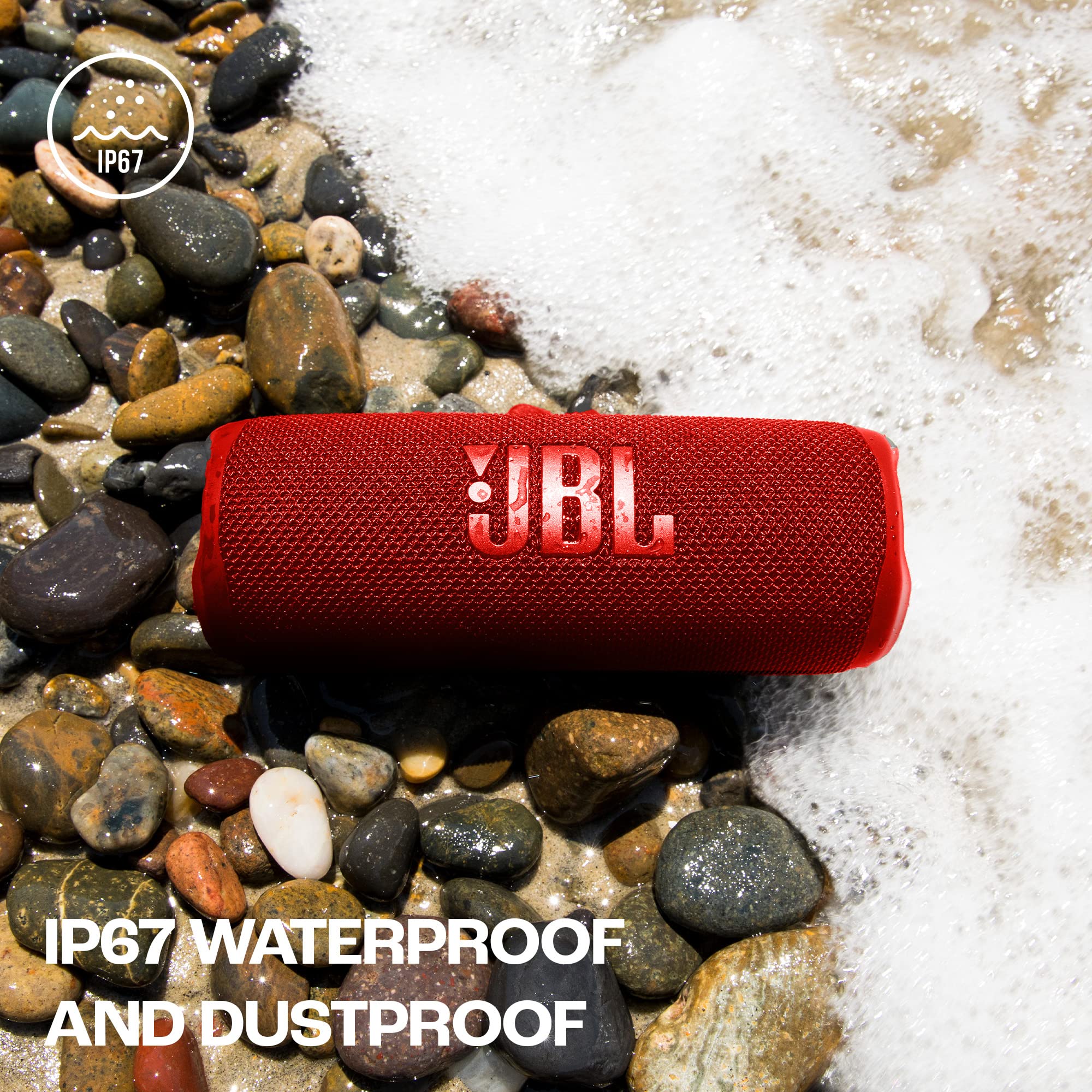 JBL Flip 6 red portable speaker on wet rocks, water splash around it