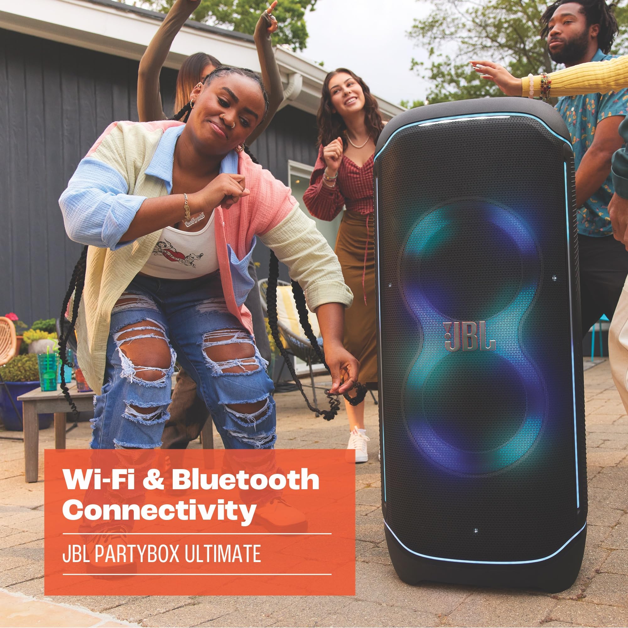 Portable Bluetooth speaker with blue LED glow, standing on floor