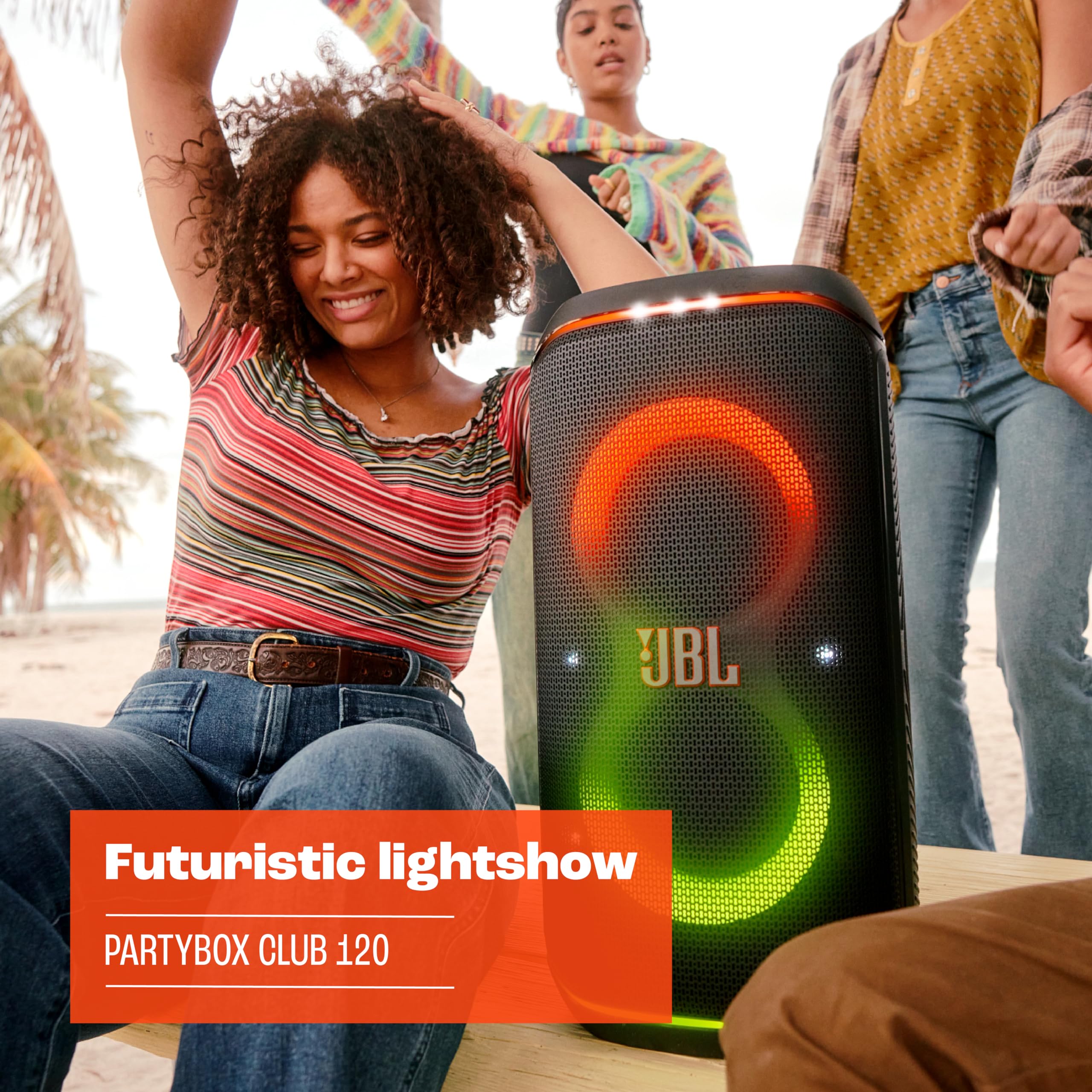 Black JBL portable Bluetooth speaker with orange and green light rings