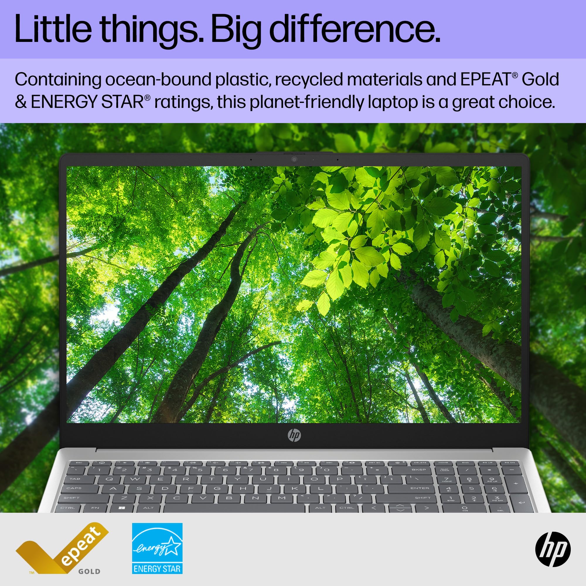 Silver HP laptop open with screen displaying forest scene and black keyboard