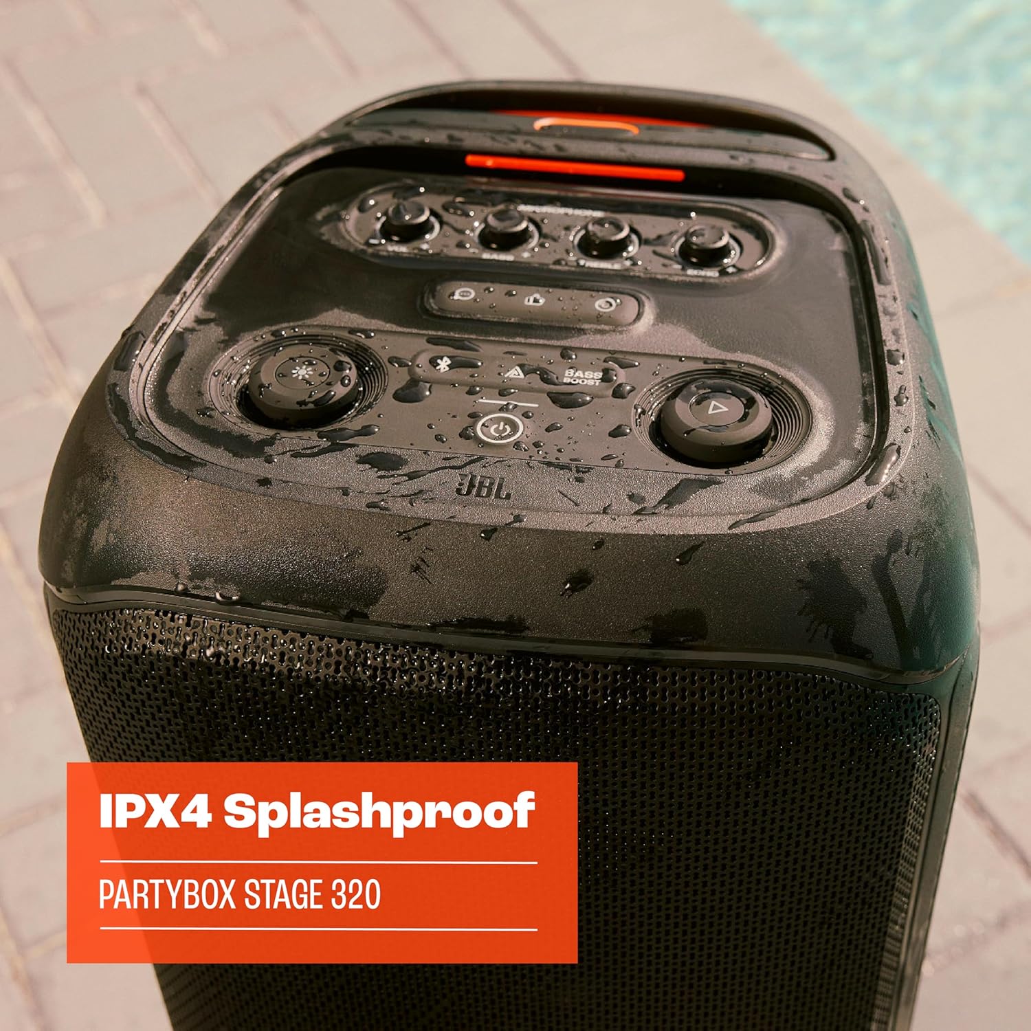Black JBL PartyBox speaker top controls with visible water droplets, splashproof