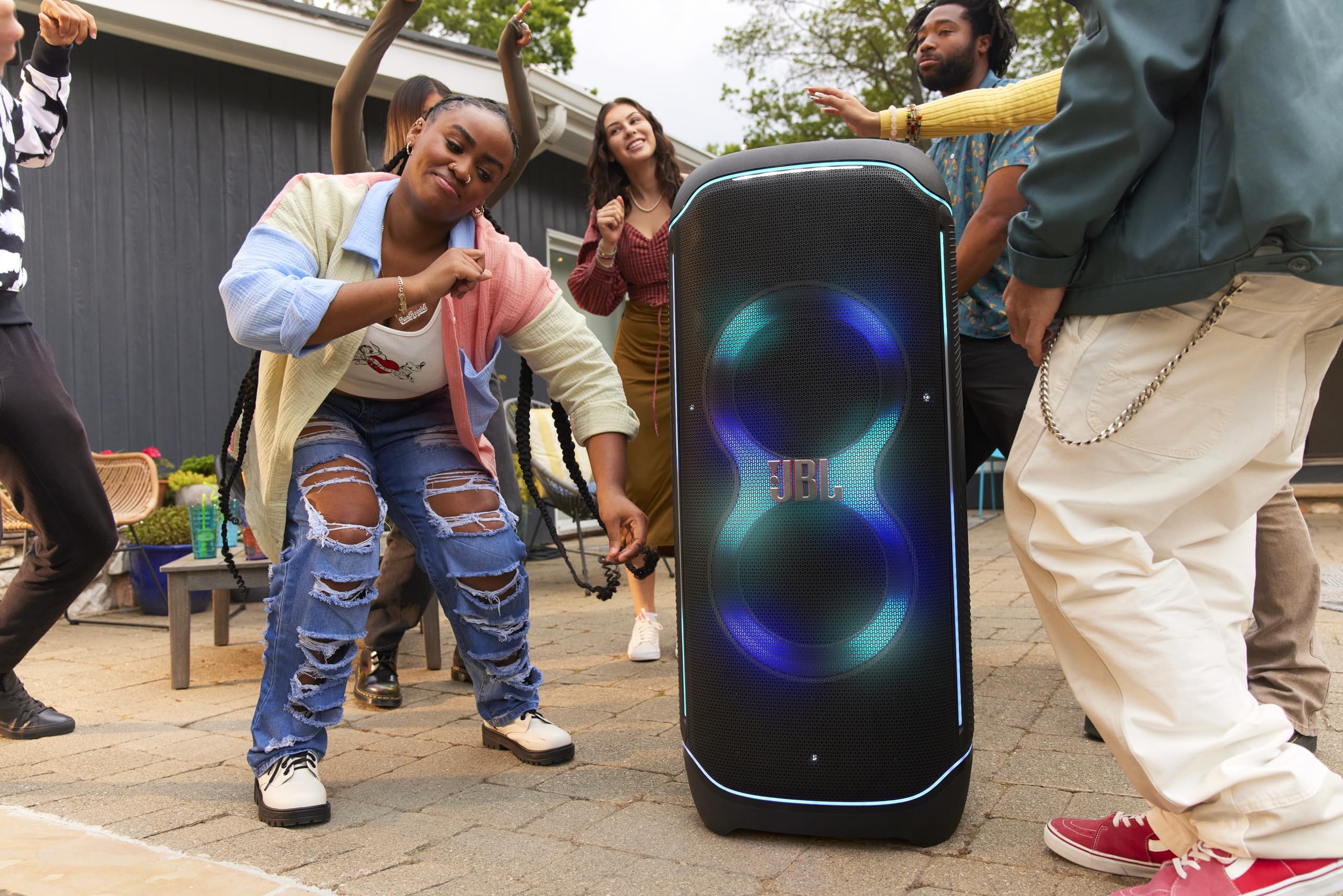 JBL portable Bluetooth speaker with blue and green light effects outdoors