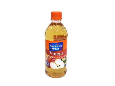 Apple cider vinegar bottle with orange cap, amber liquid, apple-flavored label