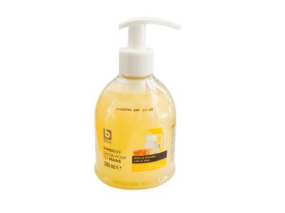 Liquid hand soap dispenser bottle with white pump, yellow liquid