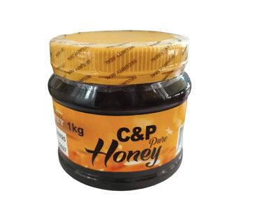 C&P Pure Honey 1kg jar with golden honey and black lid