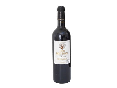 Wine bottle in dark glass with black foil top and cream label