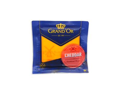 Grand'or cheddar cheese block in sealed blue wrapper, red cheddar