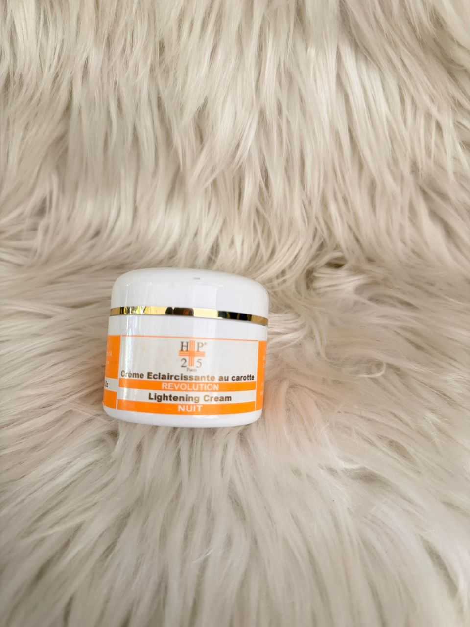 HT25 lightening cream jar with white lid and orange label