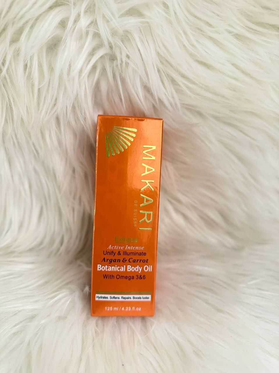 Makari botanic body oil in orange rectangular box, botanical & carrot oil