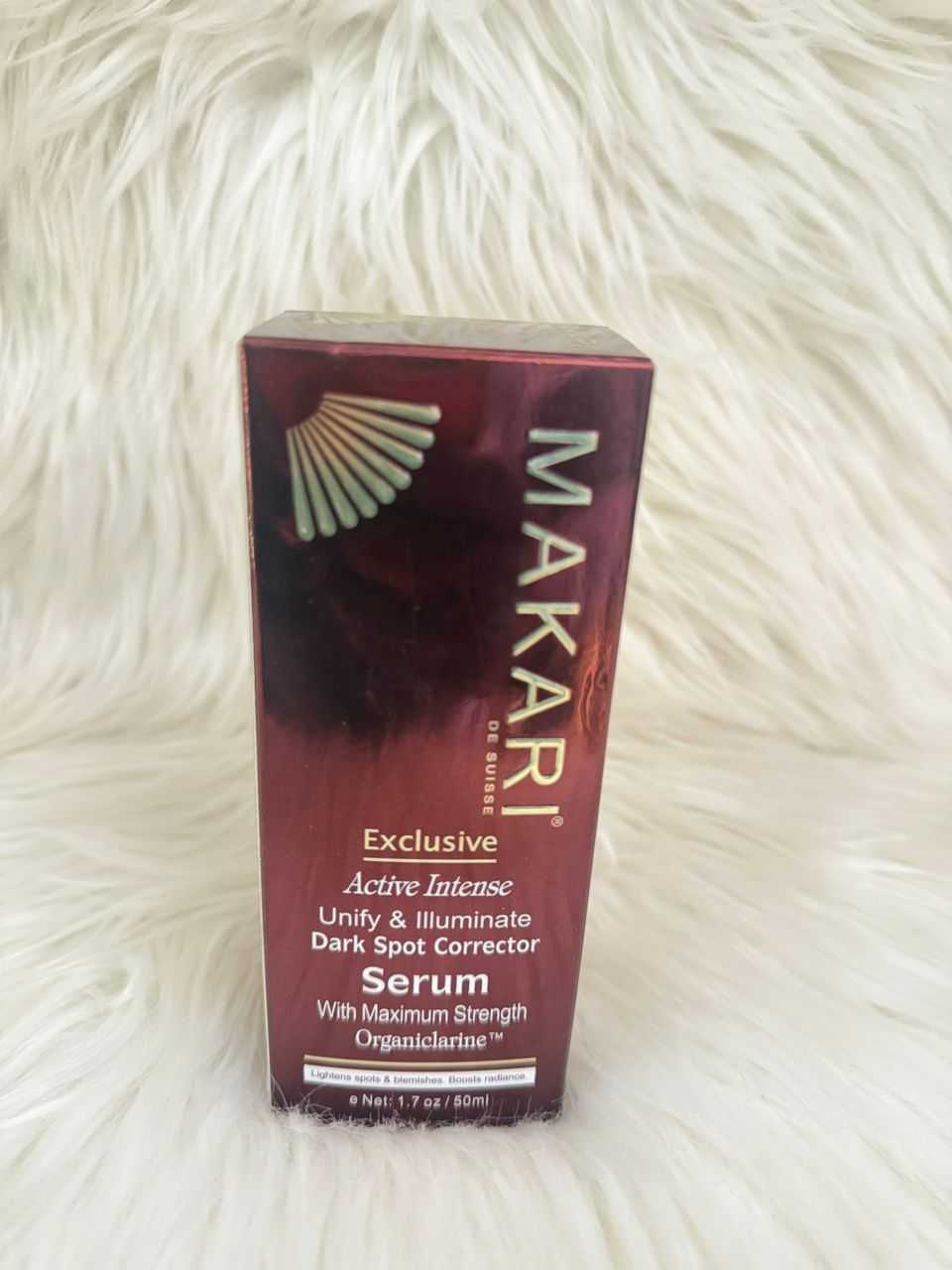 Makari dark spot corrector serum box, maroon and gold lettering