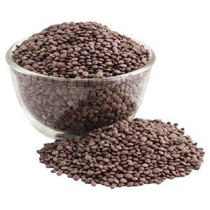 Brown masoor dal (lentils) in bowl with loose grains