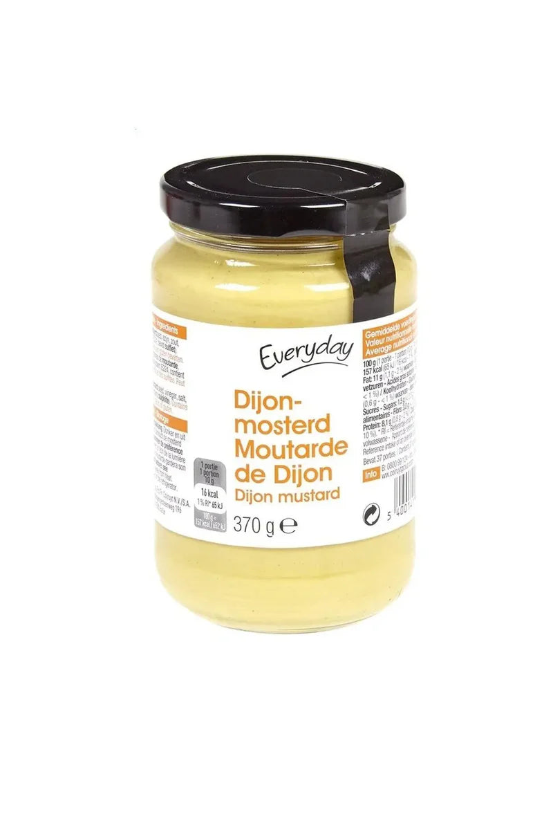 Jar of Dijon mustard with yellow contents and black screw lid