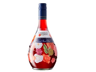 Floral wine bottle with dark blue cap and pink rose label on red liquid