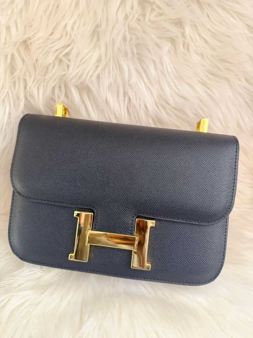 Dark leather flap handbag with gold H clasp closure