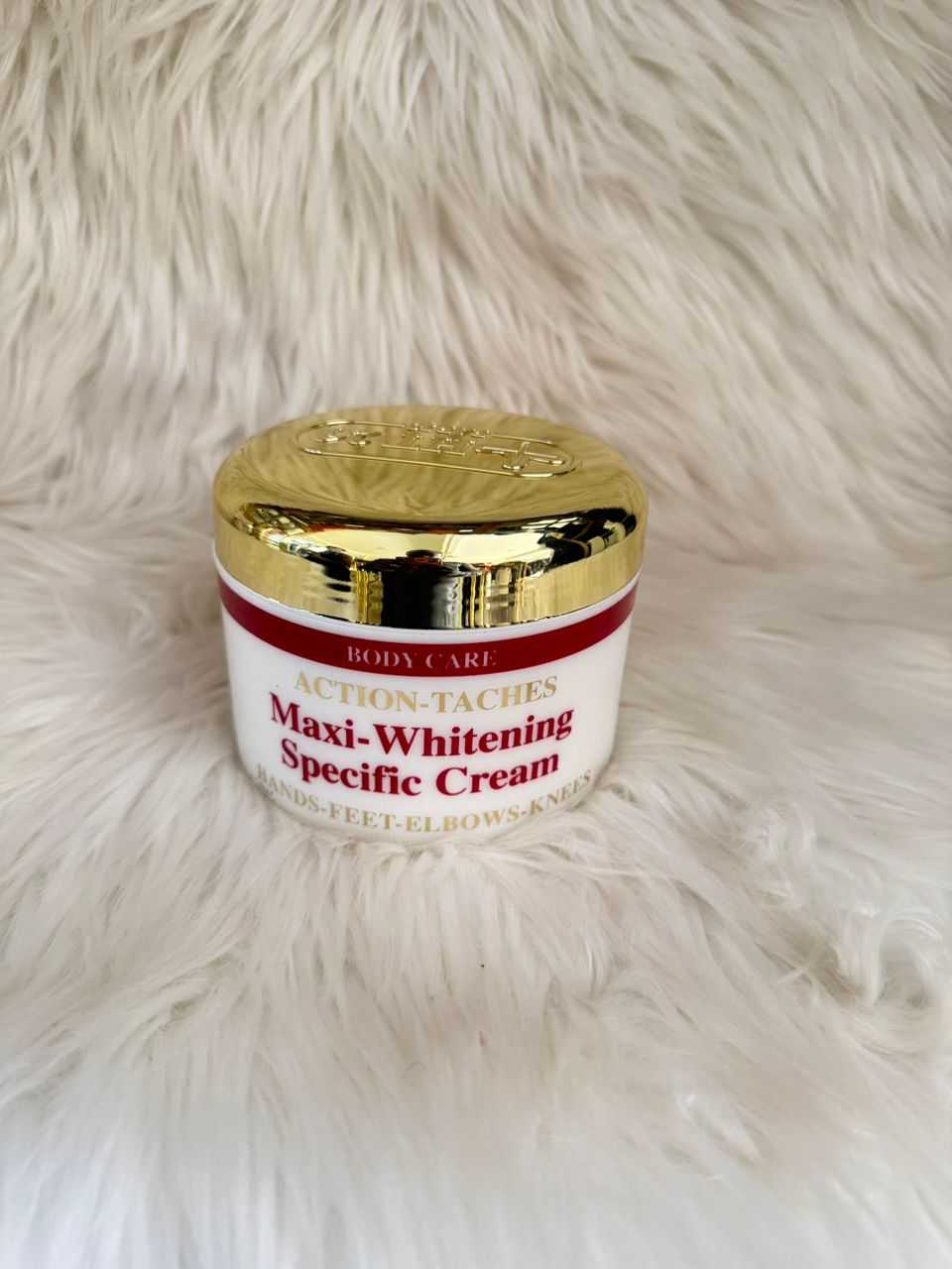 Body care cream jar with gold lid and red label for whitening, body treatment.
