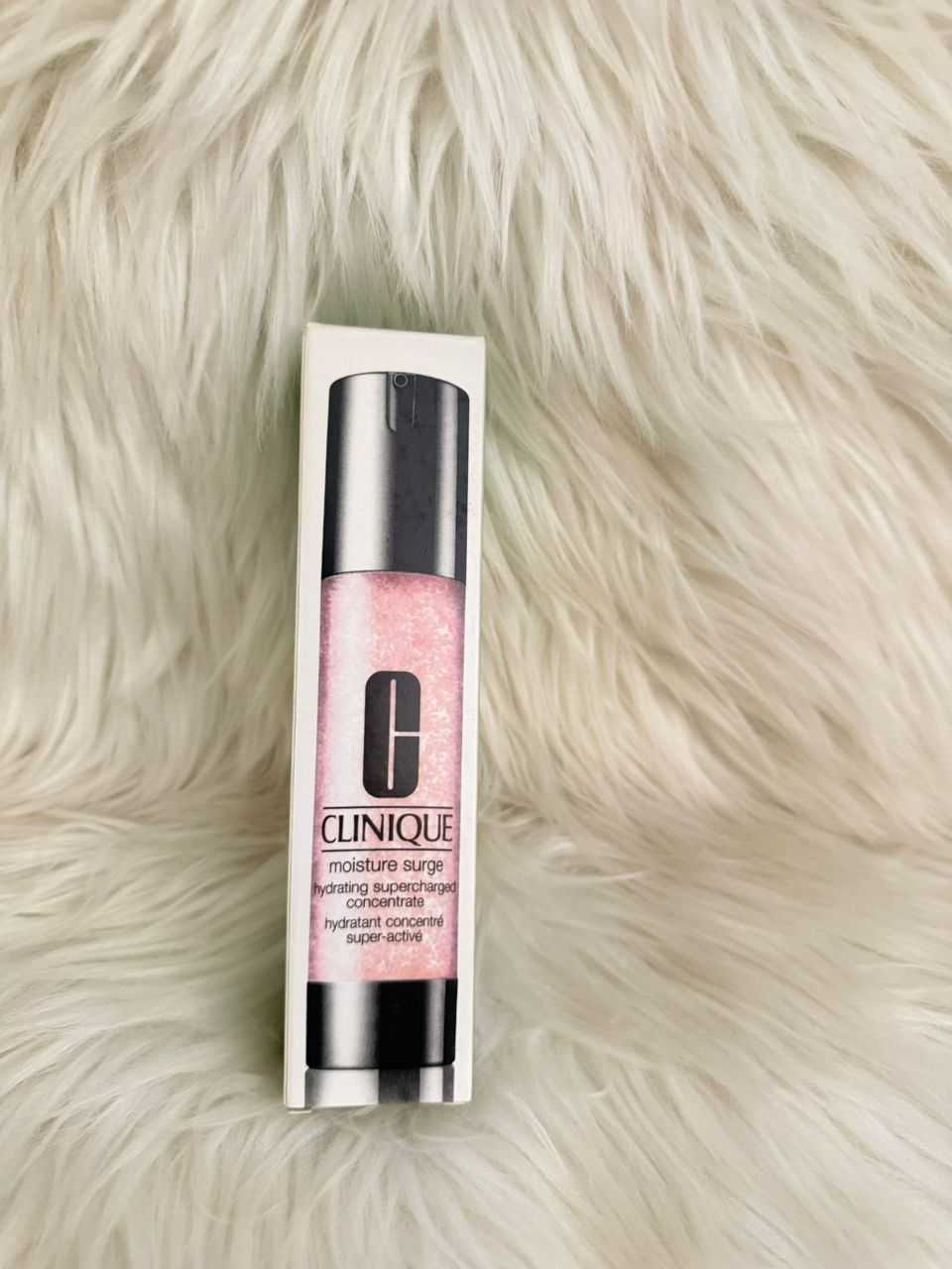 Clinique Moisture Surge moisturizer bottle with pink gel liquid; silver cap