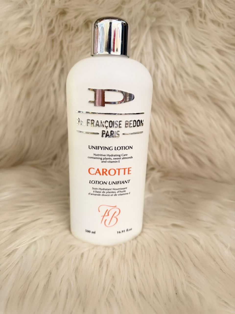 Unifying lotion bottle with silver cap and white Carotte label