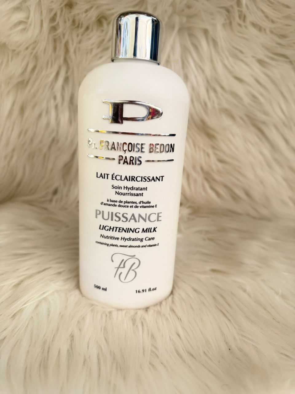 Lightening milk skincare bottle with silver pump, white label text