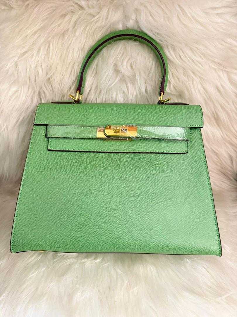 Mint green structured top-handle handbag with front flap and gold clasp