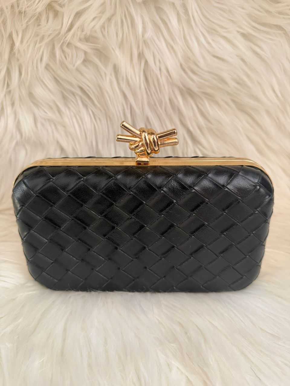 Quilted black clutch handbag with gold-tone knot clasp