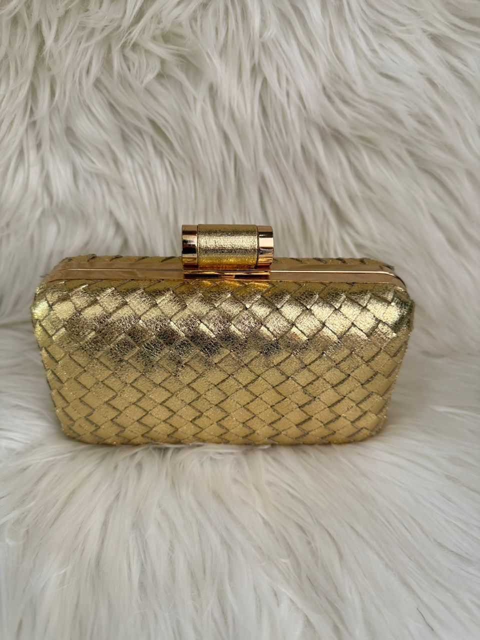 Gold woven clutch handbag with top clasp and structured frame