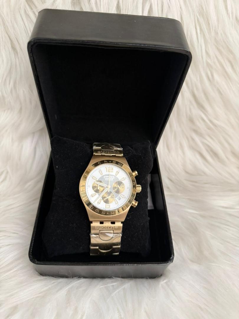 Gold-tone chronograph wrist watch with white dial, subdials, and metal bracelet