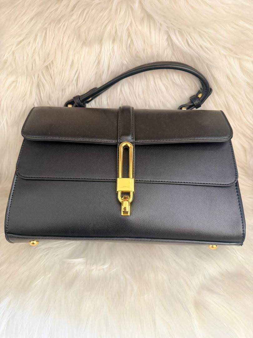 Structured black satchel with top handle, flap closure and gold-tone clasp