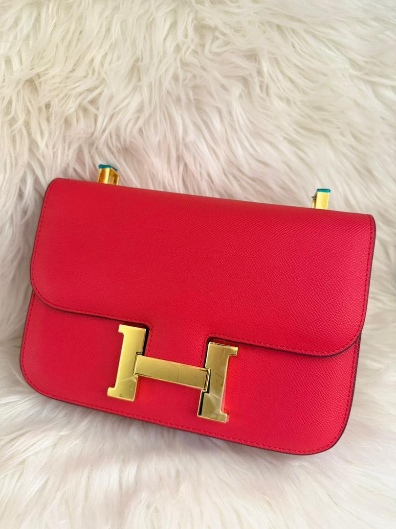 Red leather flap handbag with gold H buckle and top handle