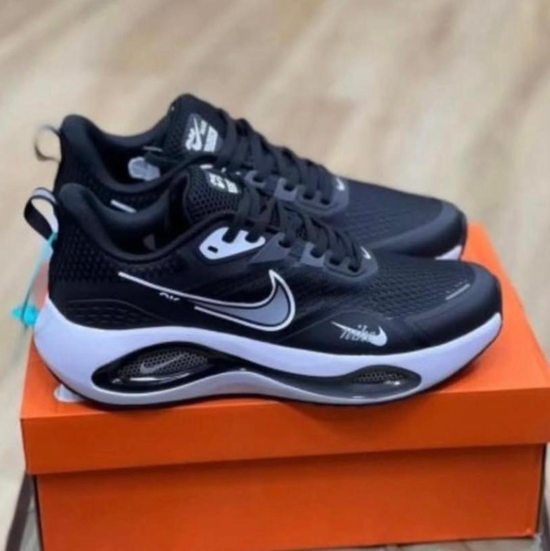 Nike Zoom black sneakers with white swoosh, lace-up, cushioned sole
