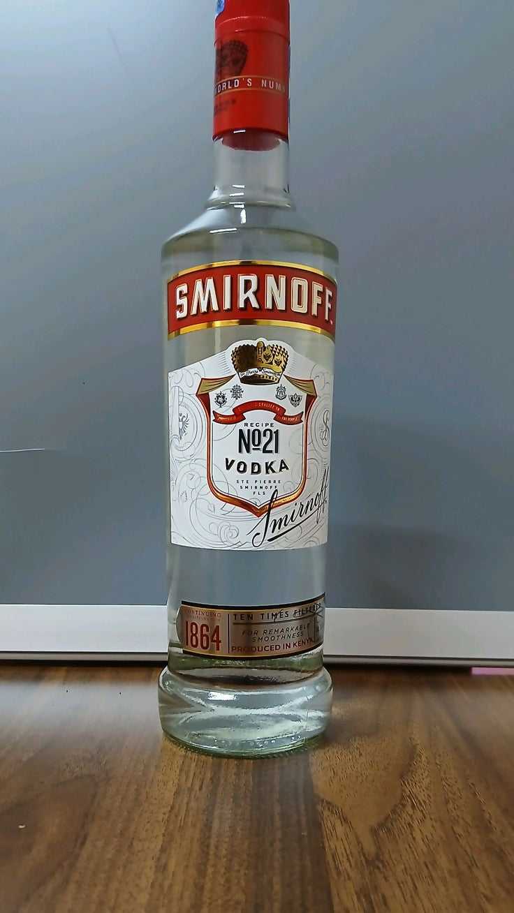 Smirnoff vodka bottle with red cap, clear glass body, No.21 label, 1L