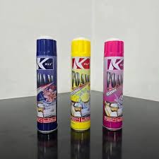 Foam cleaner aerosol cans in blue, yellow, and pink caps