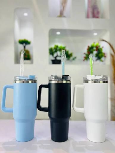 Stanley cup set: blue, black, and white tumblers with lids and drinking straws
