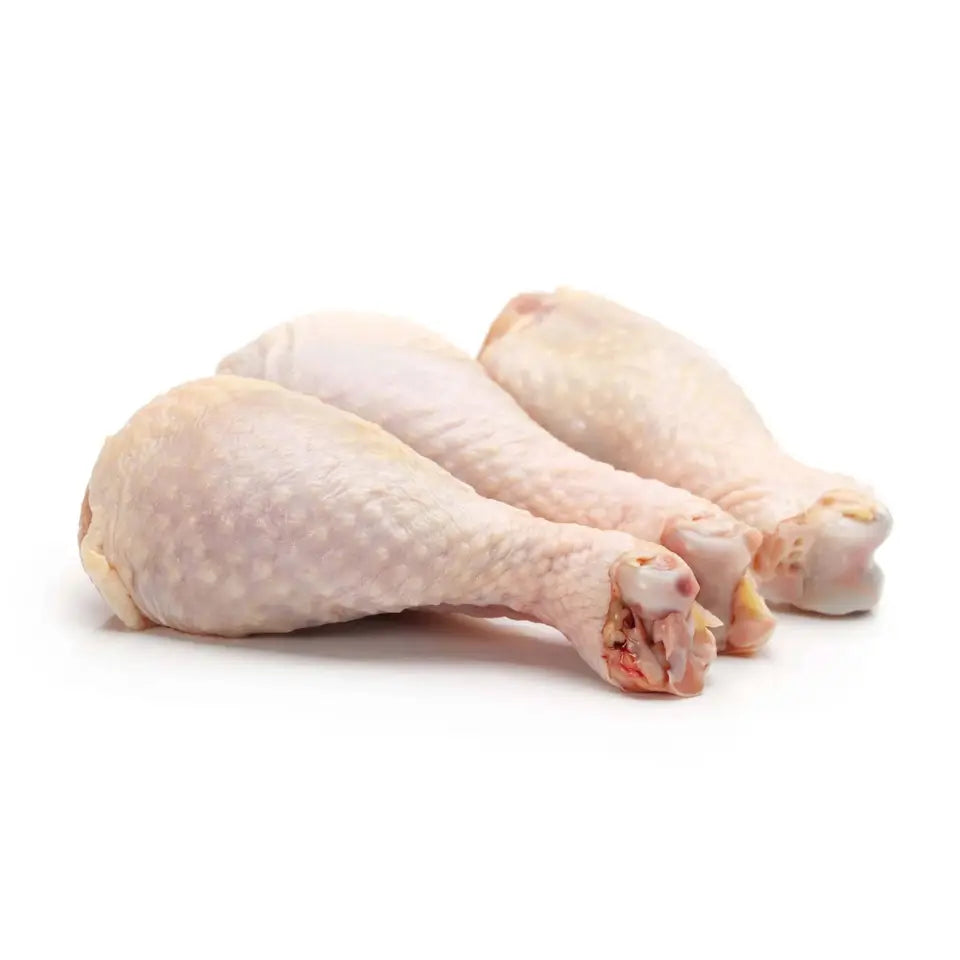 Pack of raw chicken drumsticks, pale pink skin, laid in a cluster