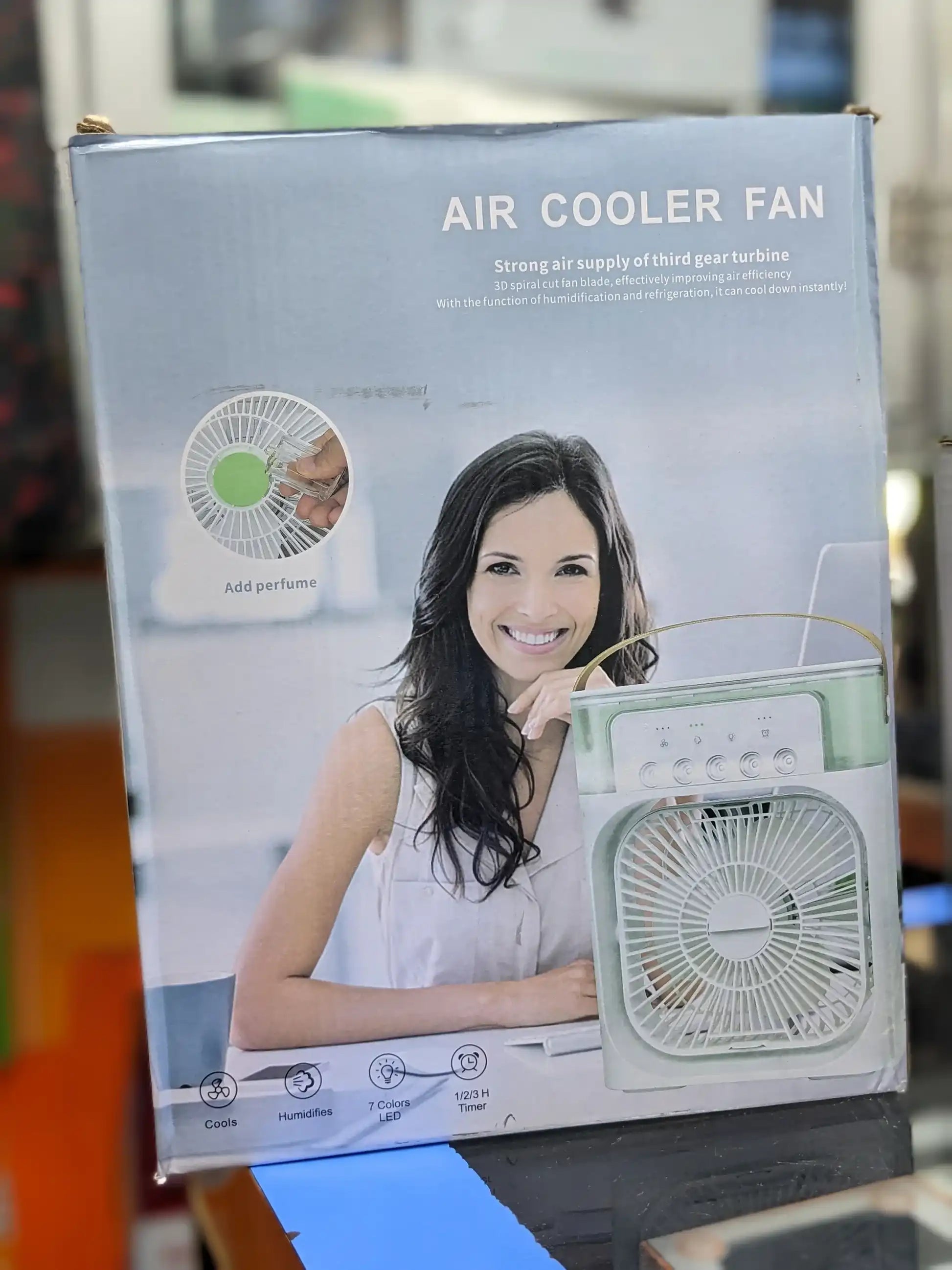 Air cooler fan retail box, showing portable square fan with front grille and control panel