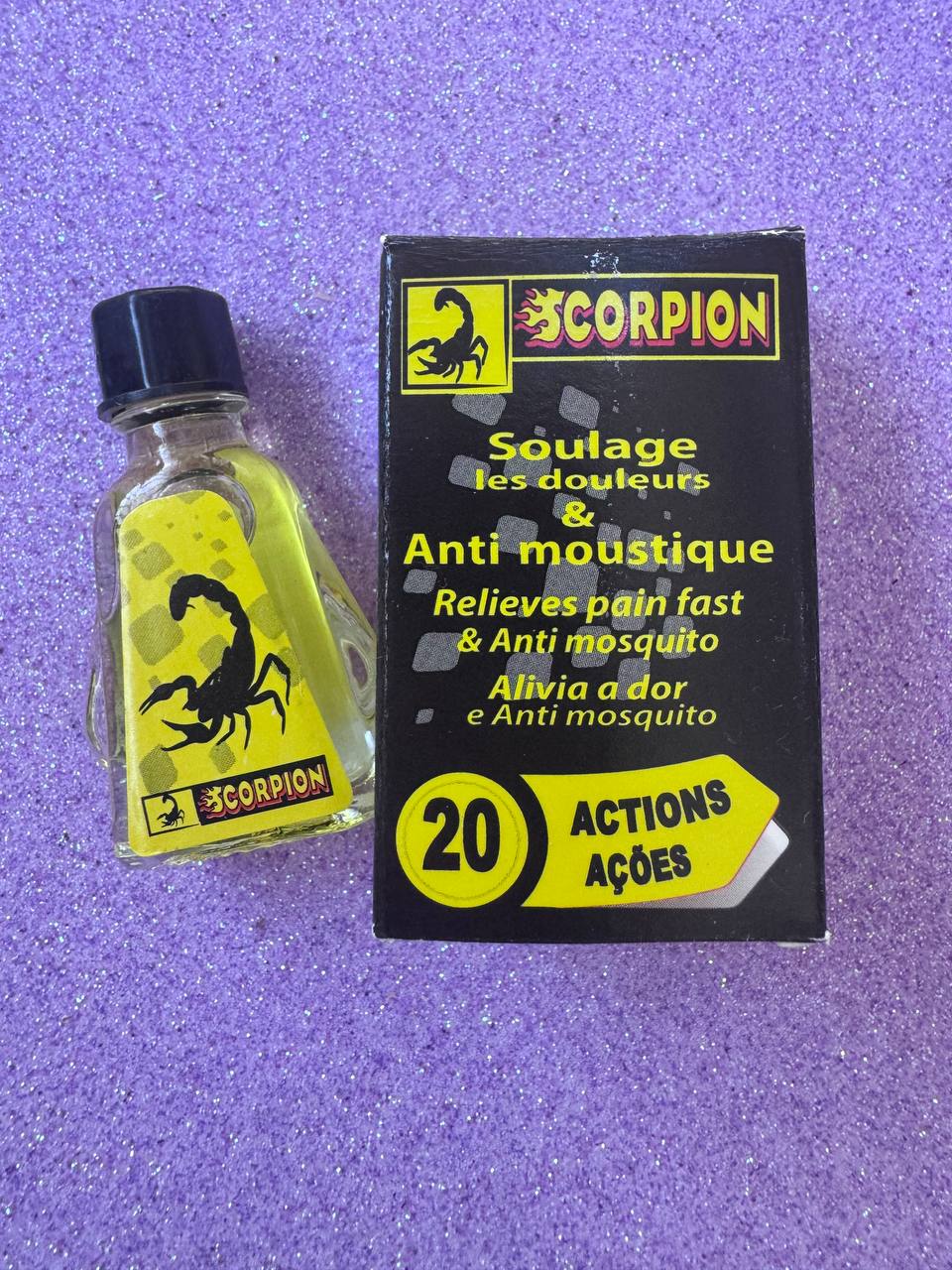 Scorpion anti-mosquito and pain relief liquid bottle with black cap, yellow-green label